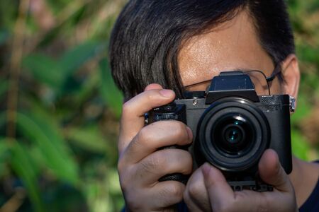 A close up asian man photographer in natureの写真素材