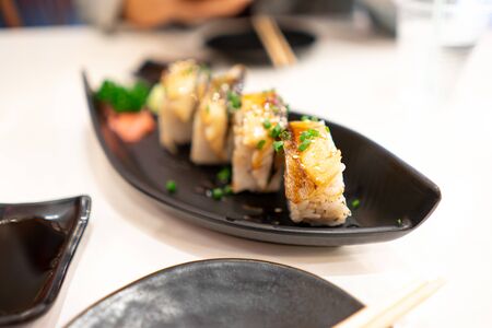 Japanese food mackerel sushi roll On a black plateの写真素材