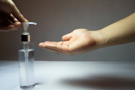 Use your hands to press the alcohol gel In the pump bottles for sterilizeの写真素材