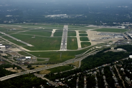 Ariel view of a runway of a medium sized US airport as viewed from the cockppit of an approaching airlinerの写真素材