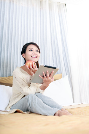 Portrait of Asian Young woman using iPadのeditorial素材