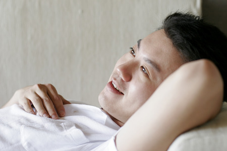 Side view of man lying downの写真素材