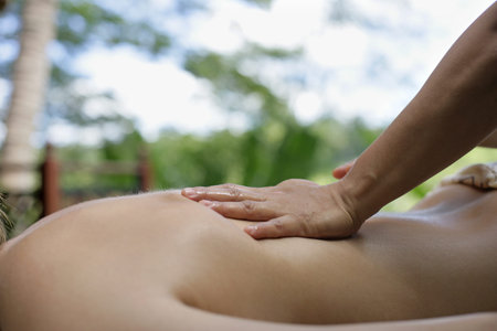 Woman receiving back massageの写真素材
