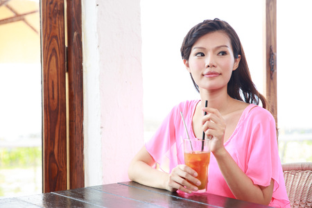 Portrait Of Asian Young Woman having drinkの写真素材