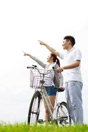 Asian young couple riding bicycleの写真素材