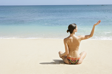 Young woman enjoying sunbath on the beachの写真素材