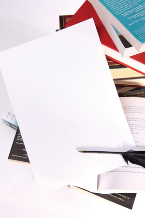 A piece of blank paper on top of book stackedのeditorial素材