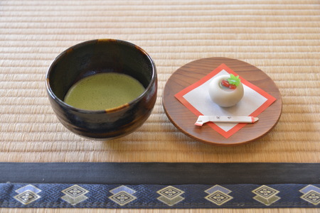 Close up view of a cup of matcha and a plate of dessertのeditorial素材