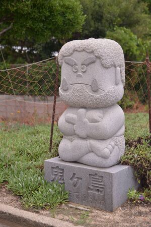 stone statue beside roadの写真素材