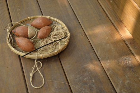High angle shot of wooden spinning top in the basket on the wooden flower in Taichungの写真素材