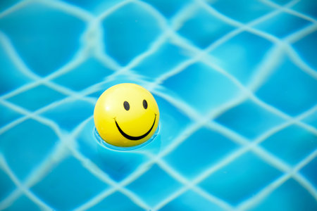 Smiley ball on swimming poolの写真素材