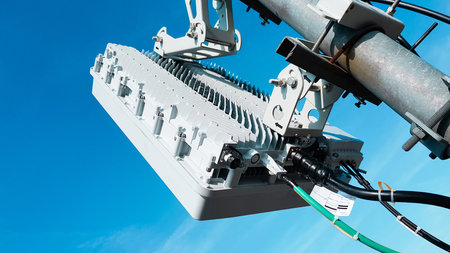 5G mobile telecommunication smart cellular radio network antennas on a mast on the roof broadcasting...
