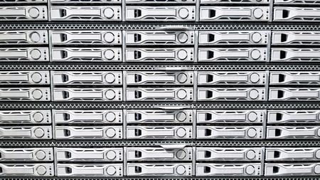 High capacity hard drive disk storage rack used for big data cloud services inside data server room close upの写真素材