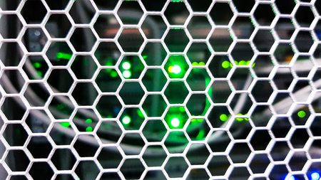 Looking through honeycomb pattern doors inside modern big data server rack in the data center with...