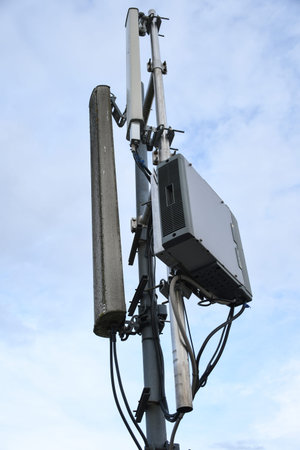 Cellular radio telecommunication network antenna mounted on a metal pole providing strong signal...