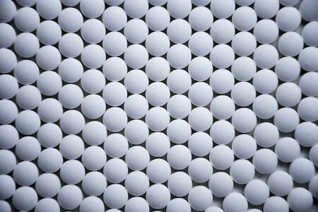 White tablets folded on a pharmaceutical factory production line close up patternの写真素材