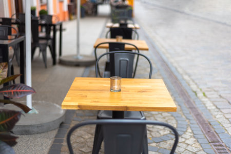 Close up shot of empty cafeteria or restaurant tables with chairs on the streetの写真素材