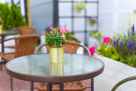 Furniture set in cafe with table and chair outdoor with flower bouquetの写真素材