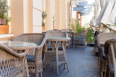 Restaurant interior tables near a restaurant. Close up shot of empty cafeteria or restaurant tables with chairs on street.の写真素材