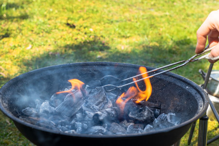 Hot empty portable barbecue BBQ grill with flaming fire and ember charcoal.の写真素材