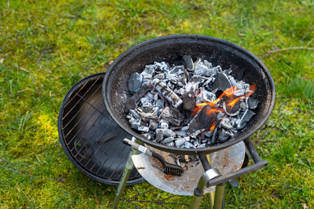 Hot empty portable barbecue BBQ grill with flaming fire and ember charcoal.の写真素材