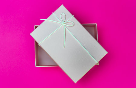 Small pink gift box on pink backgroundの写真素材