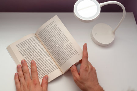The man hand holding a book on the white background.の写真素材