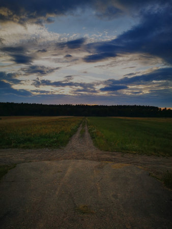 Sunset on a rural sandy road.