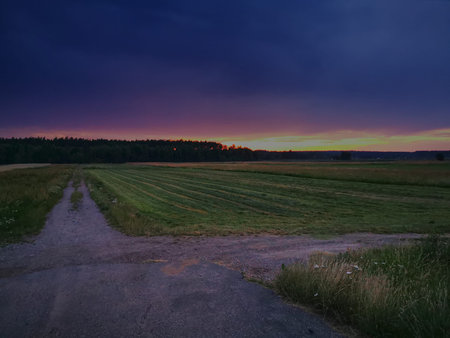 Sunset on a rural sandy road.の写真素材