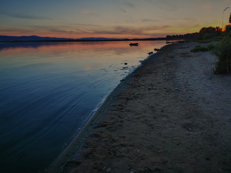 Sunset on the lake. A pontoon on the lake surface during sunset. Otmuchow Poland.
