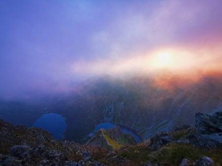 Hazy mountain peaks at sunrise. Poland Tatra Mountains. Red sunrise.