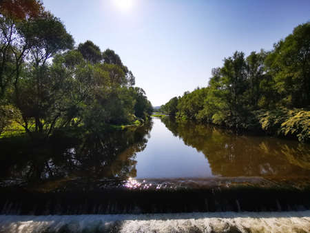 The Vistula river in the city of Ustron. Green grass in the river.の写真素材