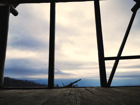 View of the cloudy sky from the wooden shepherd's house. Cottage in the mountains view through the...