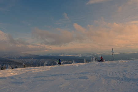 January 2021, Silesia, Poland, Hala Rysianka. Two guys on a snowmobile. Beskid Å»ywiecki, Rysianka hall.の写真素材