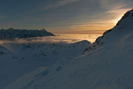 Colorful sky in the mountains during the elephant sunset. Sunset in the mountains. Clouds in a mountain valley.の写真素材