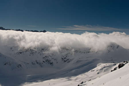 Clouds rolling over the mountain pass. Clouds in a mountain valley.の写真素材