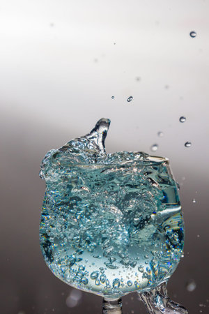 Blue water splash in a wine glass