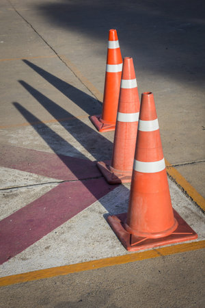 Three traffic cones blocking a parking space prohibit all kinds.の写真素材