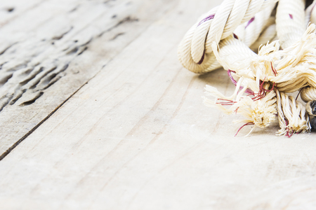 Nylon rope light brown bundle placed on a wooden table.の写真素材