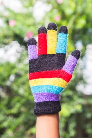 Multi-colored gloves and a symbol of the hand.の写真素材