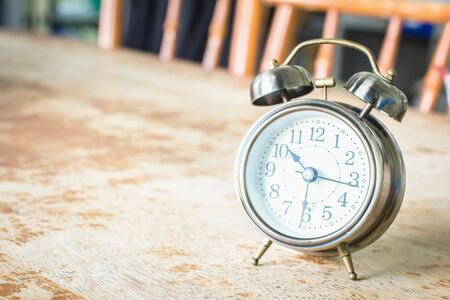 Vintage style with old alarm clock and the pace of life.の写真素材