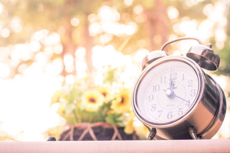 Vintage style with old alarm clock and the pace of life.の写真素材