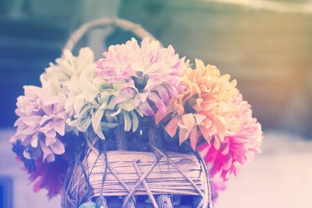 Old Artificial flowers in summer morning. Pastel tones.の写真素材