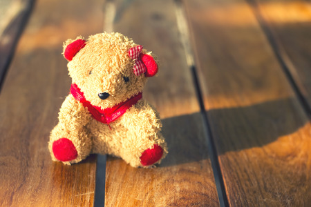 A lone teddy bear on a table. Vintage Style Classic.の写真素材