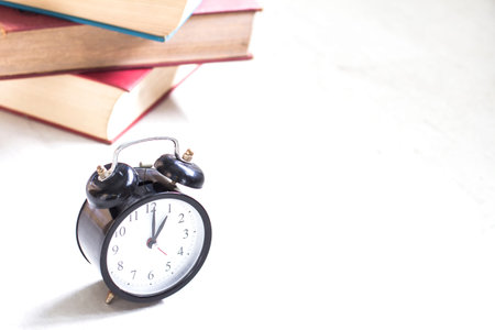 Alarm clock with books in the library