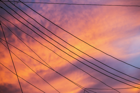 Silhouette line wire clutter with colorful sky at sunset.の写真素材