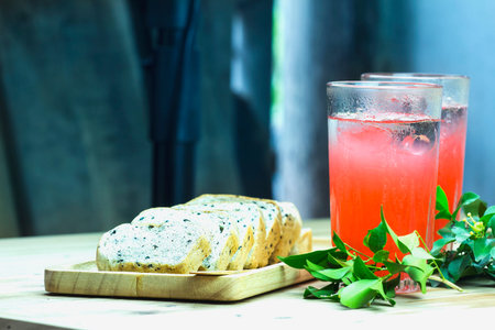 Food breakfast with juice and bread on a wooden table.