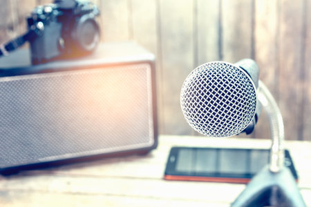 Analog microphone on a wooden table.の写真素材