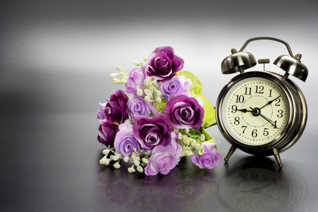 Golden alarm clock with flower.の写真素材