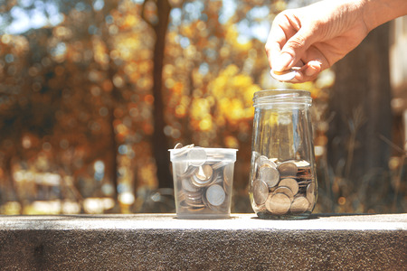 Concept of saving money by collecting coins in a glass jar. Money Thailand.の写真素材